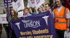 student nurses hold a banner