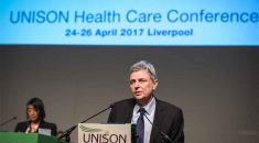 Dave Prenits at the rostrum speaking to UNISON health delegates in Liverpool