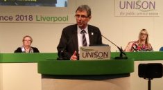 Dave Prentis stands at rostrum addressing UNISON women's conference