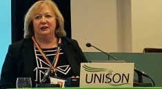 Christina McAnea speaking at the rostrum at UNISON higher education conference