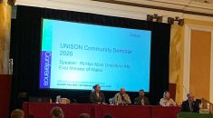 picture of platform at UNISON community seminar with Mark Drakeford speaking at rostrum