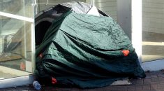 Tent of a homeless person in a commercial doorway