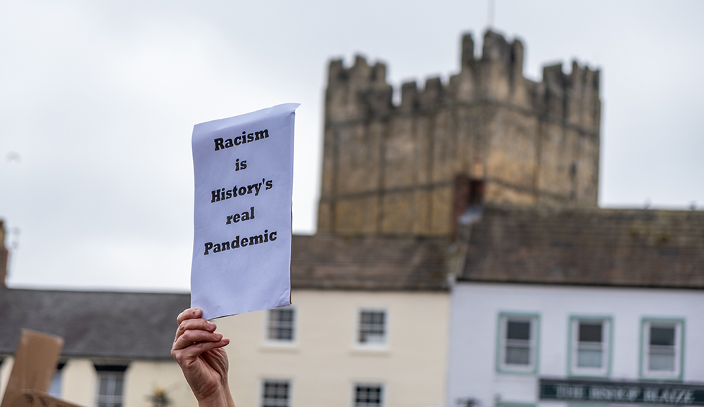 anti-racism message being held by Black hand in Richmond, Yorkshire