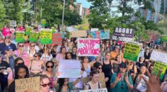 Hundreds of protestors hold pro-abortion placards