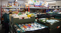 Crass and shelves of tinned and packet food in a food bank