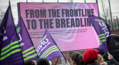 UNISON flags wave in front of a Pink ad-van which reads - From the frontline to the breadline