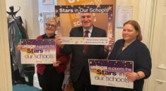 Sue Ryles, John McDonnell and Claire Stanhope hold Stars In Our Schools signs