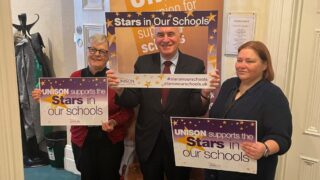Sue Ryles, John McDonnell and Claire Stanhope hold Stars In Our Schools signs