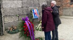 Paddy Toner and Hellen Illidge pay tribute at the Wall of Memorial, Auschwitz