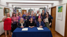 Christina McAnea at a table with the leader and CEO of Newcastle City Council, to sign a Disability Employment Charter, with members standing behind them