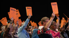 Delegates raise voting cards at UNISON local government conference