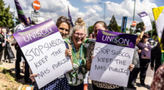 Three women holding UNISON placards that say 'Stop Subcos - Keep the NHS public'