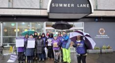 UNISON members holding signs on their picket line reading 'no pay, no way' and 'fair pay now'
