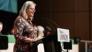 Tanya Pretswell speaking at podium