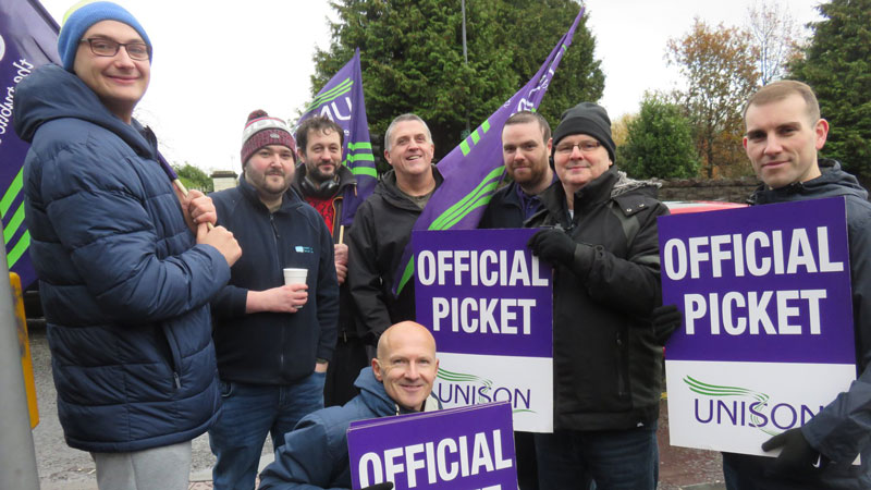 UNISON strikers with their 'official picket' signs