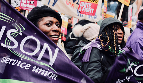 Black woman smiling with a UNISON flag
