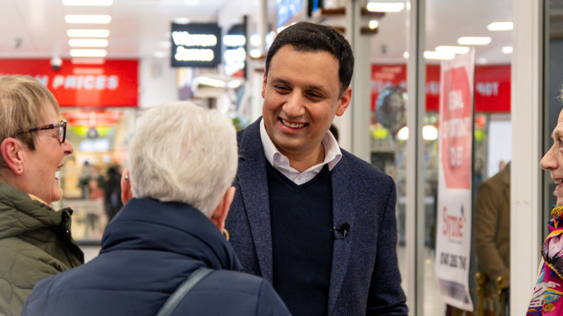 Anas Sarwar speaking to customers in a supermarket