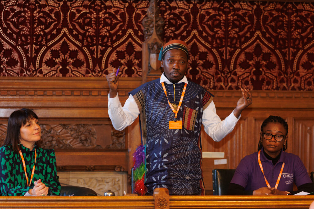 Adekunle, a migrant care worker and activist, speaking at a lobby in the Westminster parliament