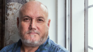 Andy Hewston sits by a window