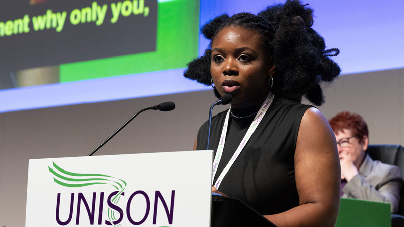 A young Black woman and first-time delegate speaking at the podium 
