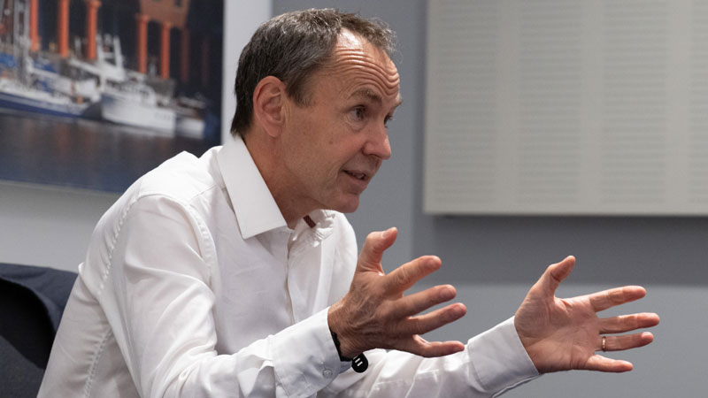 Mike Berners-Lee sitting at a table talking in an animated way