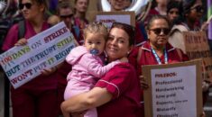 Phlebotomist stands holding her child