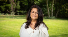 Portrait of Bindu Parmar, in a part with trees behind her