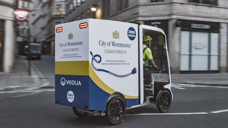 A small electric vehicle being driven around the streets