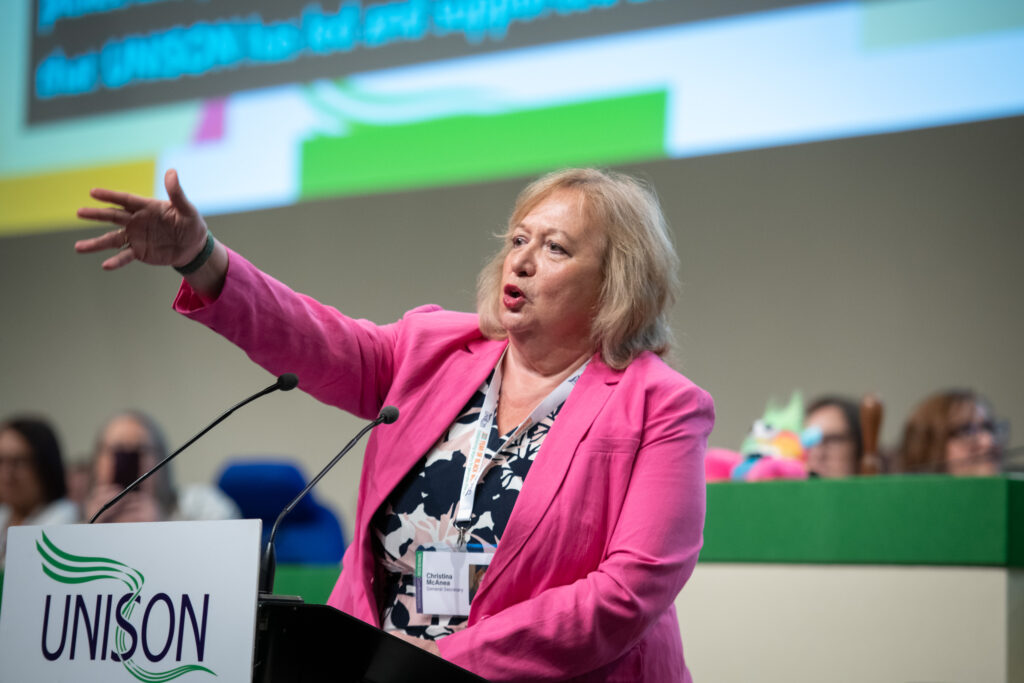 Christina McAnea speaking at a conference podium