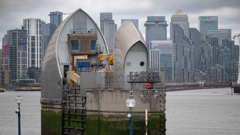 The Thames Barrier, with the high rise buildings of Canary Wharf behind it