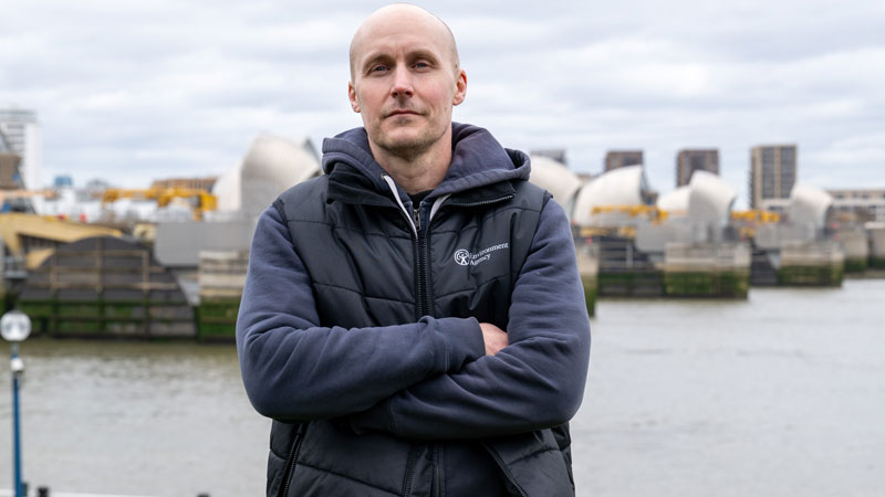 Jamie Butcher, with the Thames Barrier behind him